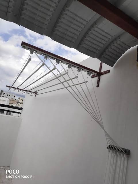Pulley cloth hanger installed in Bangalore apartment balcony for clothes drying